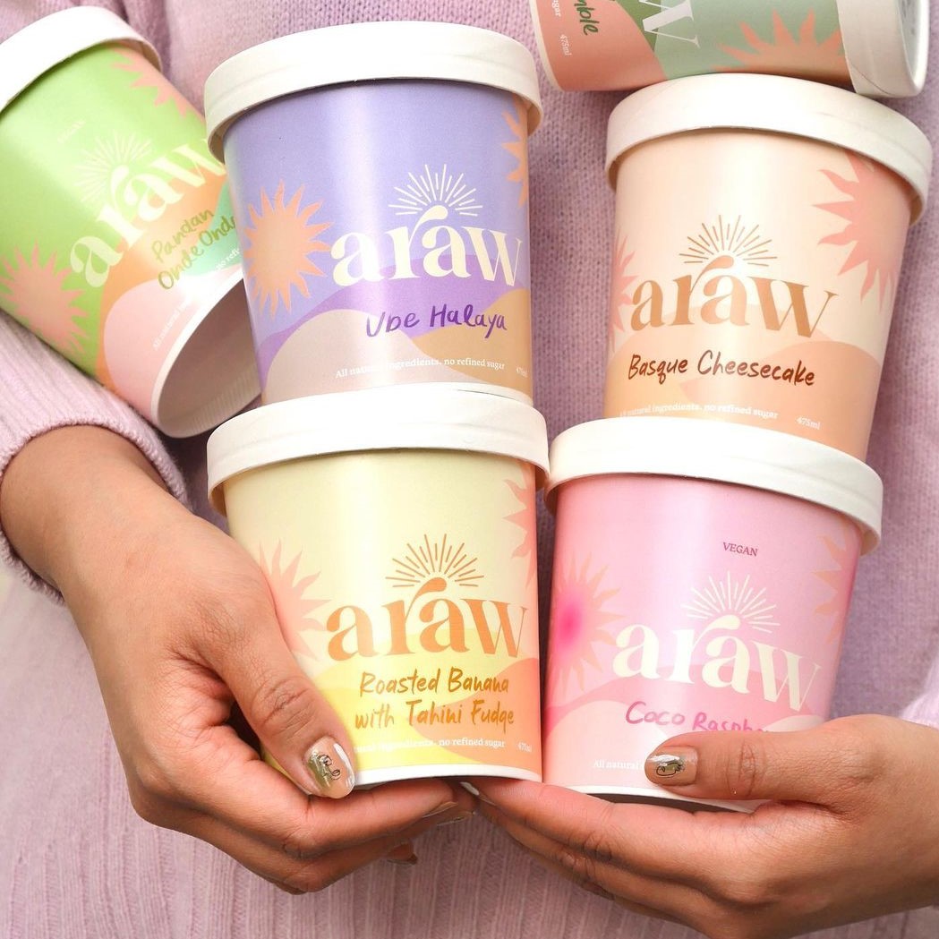 Person holding tubs of Araw desserts
